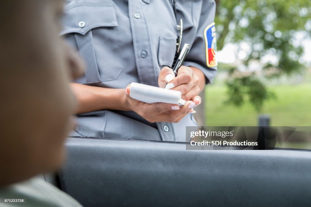 Driver waits as police officer writes speeding ticket