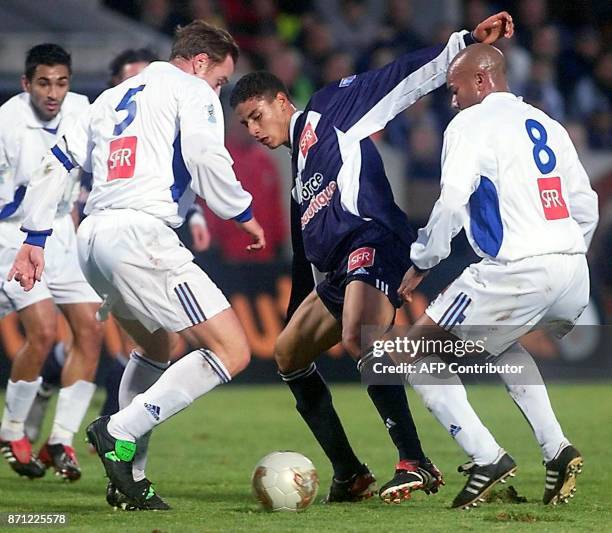L'attaquant Marouane Chamakh tente de récupérer le ballon de ses adversaires grenoblois, dont le défenseur Hervé Milazzo et le milieu de terrain...