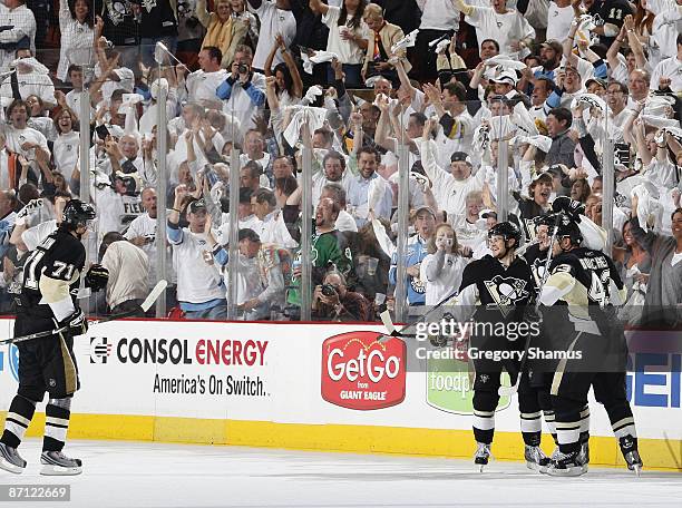 Mark Eaton of the Pittsburgh Penguins celebrates his goal with Chris Kunitz and Philippe Boucher against the Washington Capitals during Game Six of...