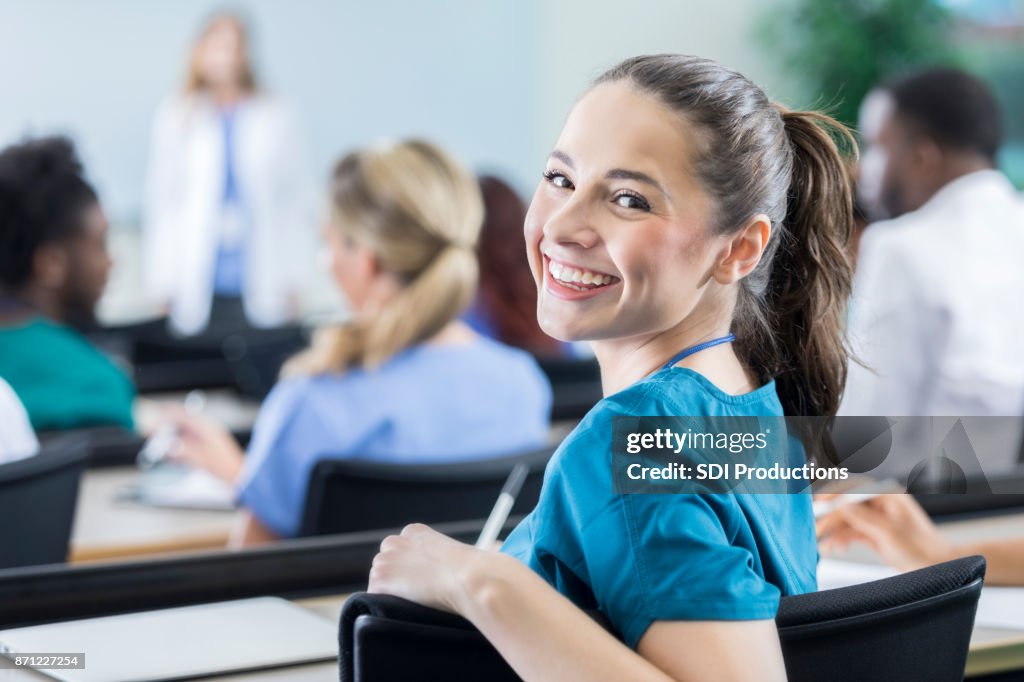 Cheerful female medical student in the classroom