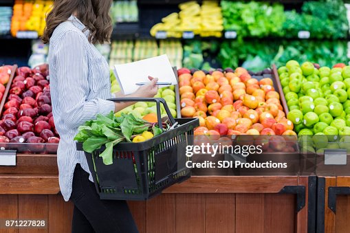 Unrecognizable woman shops for produce in supermarket Unrecognizable woman shops for produce in supermarket