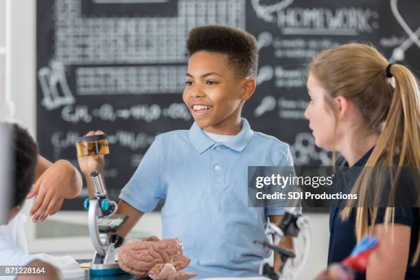 schoolboy holds a specimen container in biology class - brain in a jar stock pictures, royalty-free photos & images