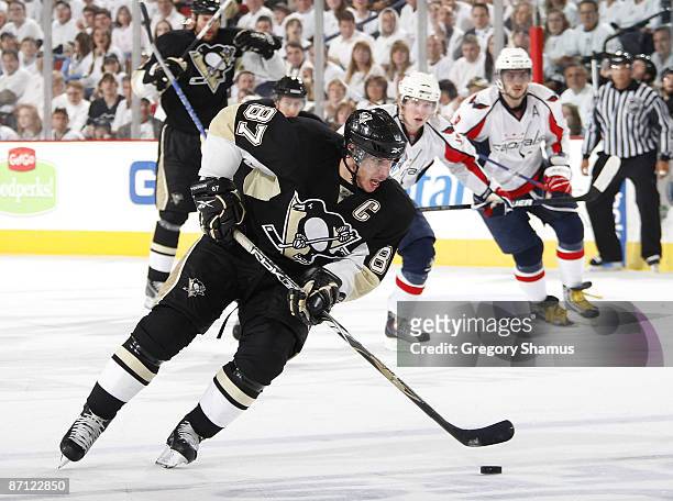 Sidney Crosby of the Pittsburgh Penguins moves the puck up ice in front of Alex Ovechkin of the Washington Capitals during Game Six of the Eastern...