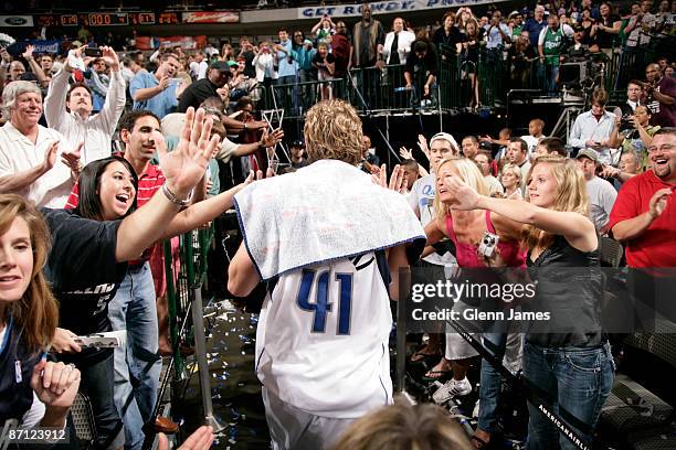 Dirk Nowitzki of the Dallas Mavericks is congratulated by the fans after a win against the Denver Nuggets in Game Four of the Western Conference...