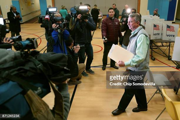 Surrounded by journalists, Republican candidate for Virginia governor Ed Gillespie casts his vote in the gymnasium at Washington Mill Elementary...