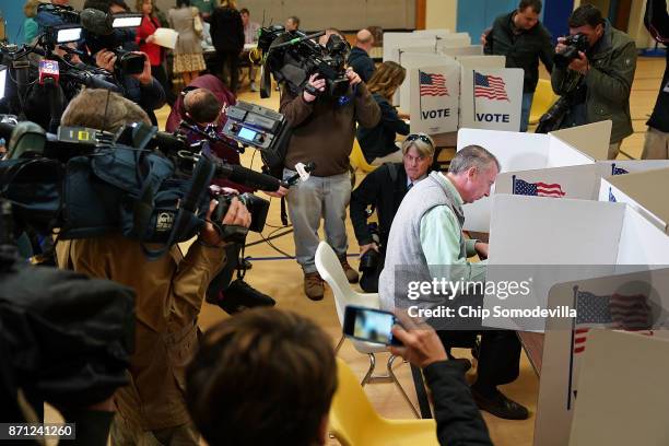 Surrounded by journalists, Republican candidate for Virginia governor Ed Gillespie fills out his ballot in the gymnasium at Washington Mill...