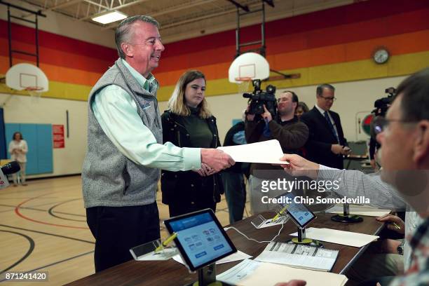 Republican candidate for Virginia governor Ed Gillespie receives his ballot while voting in the gymnasium at Washington Mill Elementary School...
