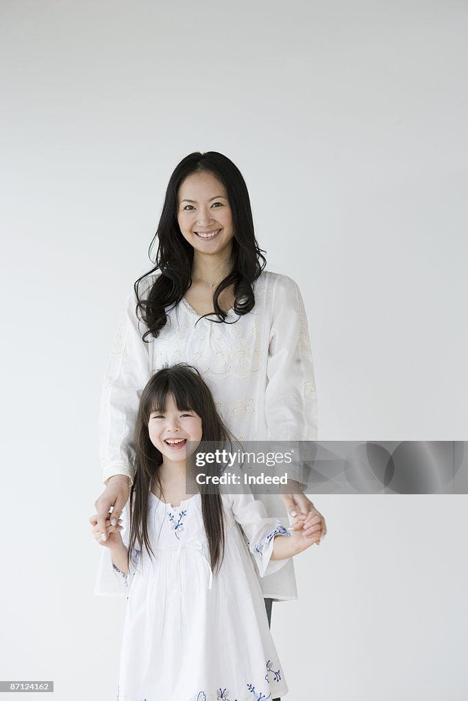 Portrait of mother and daughter (8-9)