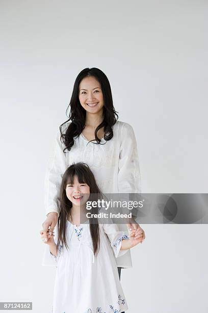 portrait of mother and daughter (8-9) - mother on white background stock pictures, royalty-free photos & images