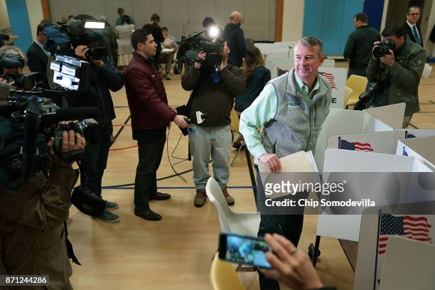 Surrounded by journalists, Republican candidate for Virginia governor Ed Gillespie casts his vote in the gymnasium at Washington Mill Elementary...