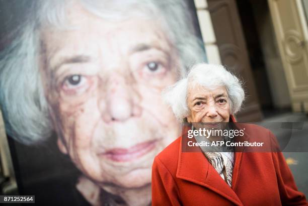 Holocaust survivor Margot Friedlander stands in front of her portrait by photographer and filmmaker Luigi Toscano during a preview of the exhibition...