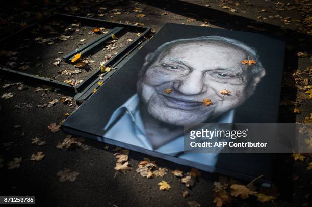 The portrait of a Holocaust survivor by photographer and filmmaker Luigi Toscano lays on the ground as it is made ready to be fixed during a preview...