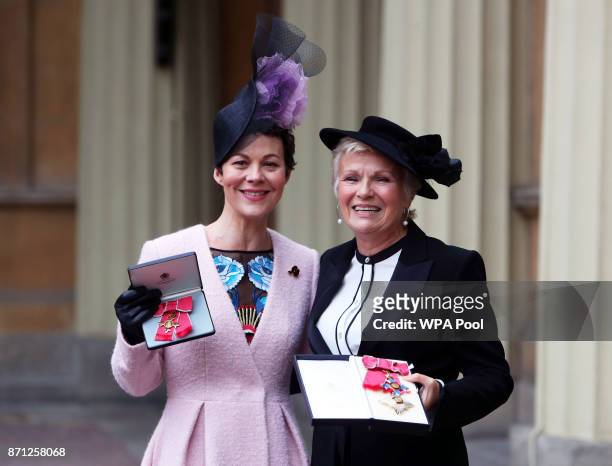 Dame Julie Walters and Helen McCrory pose after they awarded a Damehood and OBE respectively by Queen Elizabeth II at an Investiture ceremony at...