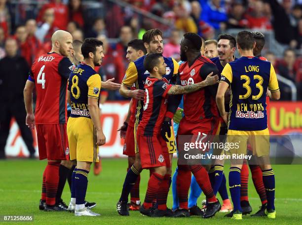 Jozy Altidore of Toronto FC argues with Damien Perrinelle and Sacha Kljestan of New York Red Bulls during the first half of the MLS Eastern...