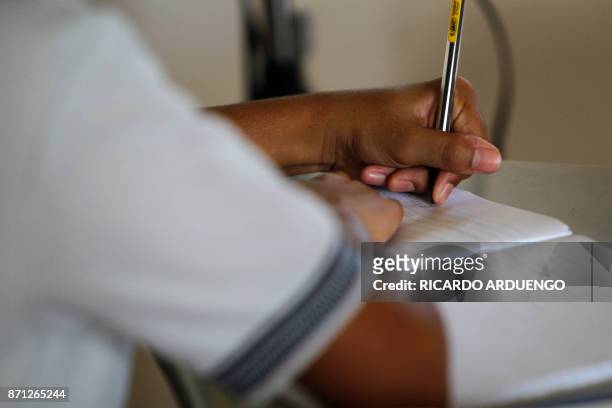 6th grade student takes notes during an English class at the Sotero Figueroa Elementary School in San Juan, Puerto Rico, November 6, 2017. The school...