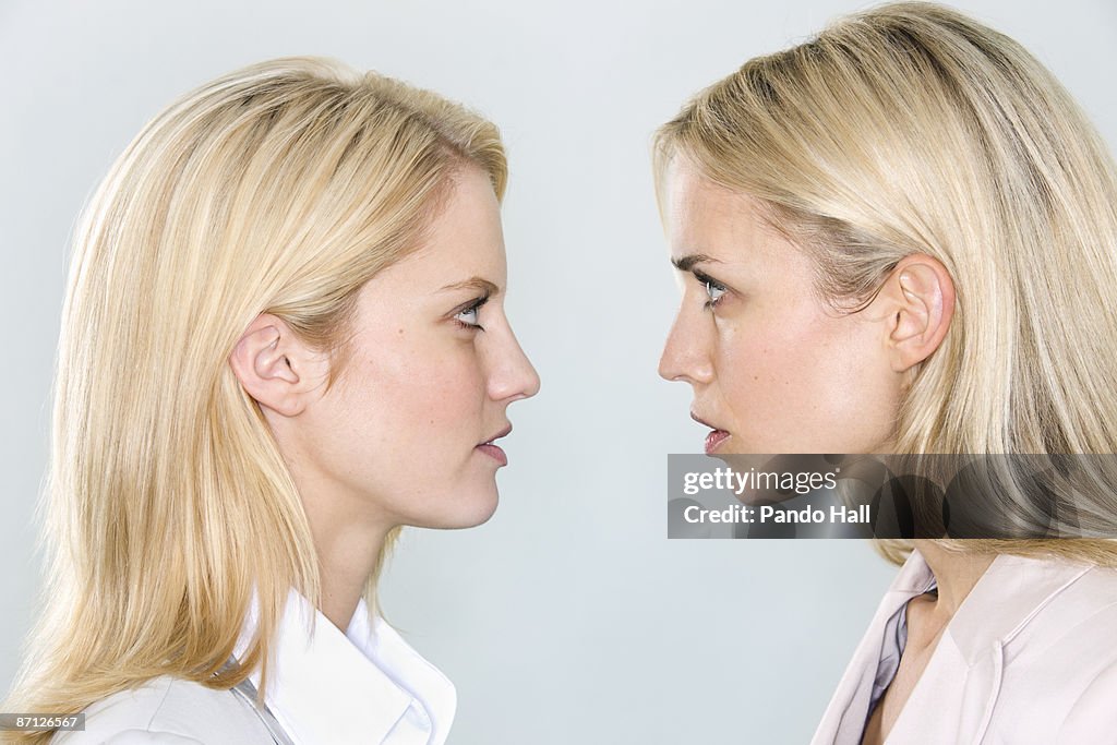 Two women looking at each other, profile