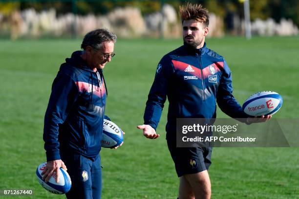 French national rugby union team head coach Guy Noves talks with with fullback Hugo Bonneval during a training session in Marcoussis, near Paris, on...