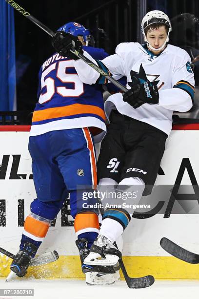 Johnny Boychuk of the New York Islanders checks Melker Karlsson of the San Jose Sharks at Barclays Center on October 21, 2017 in the Brooklyn borough...