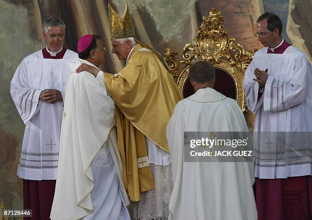 Pope Benedict XVI greets Fuad Twal , the head of the Latin Patriarch of Jerusalem, at the beginning of a mass at the Gethsemane Garden, in the Kidron...