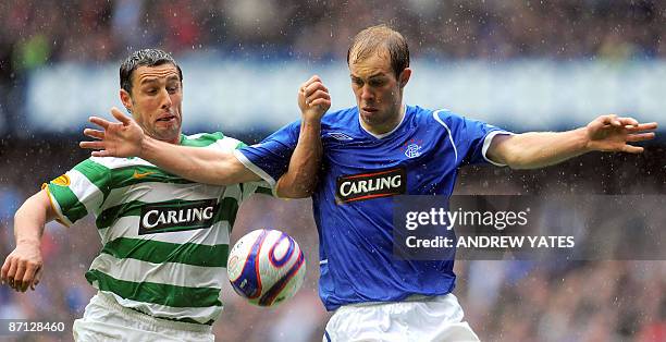 Celtic's Australian forward Scott McDonald vies with Rangers' Scottish midfielder Steven Whittaker during the Scottish Premier League football match...