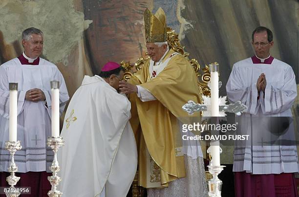 Latin Patriarch of Jerusalem head Fuad Twal kisses the hand of Pope Benedict XVI during mass at the Gethsemane Garden, in the Kidron valley between...