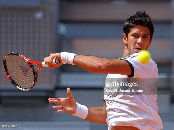 Fernando Verdasco of Spain plays the ball to his fellow countryman Juan Carlos Ferrero in his first round match during the Madrid Open tennis...