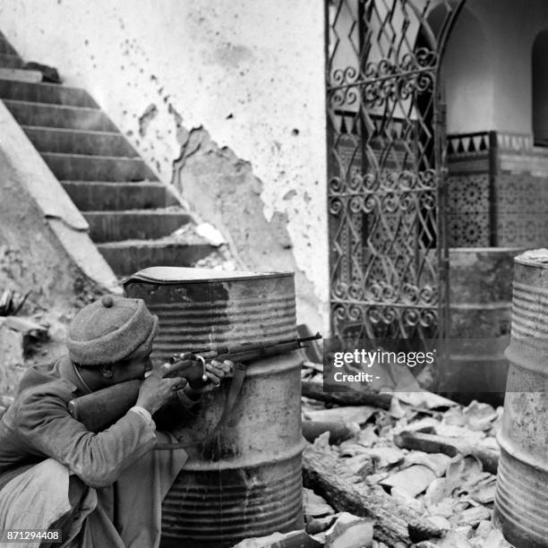Fighter holds his gun during fightings in Tiliuin near Sidi Ifni between Moroccan and Spanish troups, in December 1957, in Spanish Morroco, during...