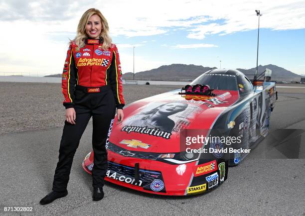 Funny Car driver Courtney Force poses with her Advance Auto Parts Chevrolet Camaro SS funny car featuring the cover of Big Machine Records recording...