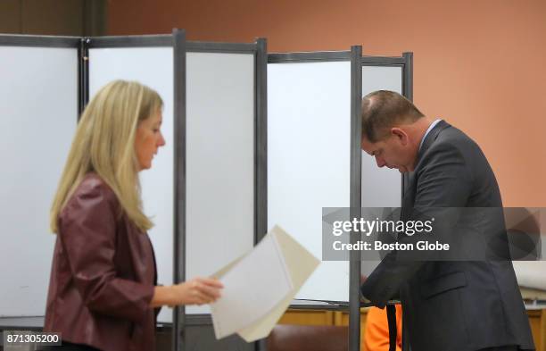 Boston Mayor Martin J. Walsh, right, and his partner Lorrie Higgins, left, vote at the Lower Mills Branch of the Boston Public Library in Boston,...