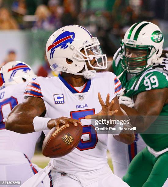 Quarterback Tyrod Taylor of the Buffalo Bills sets to pass under pressure from Steve McLendon of the New York Jets in the first half of an NFL...