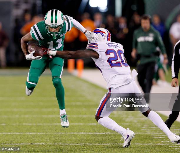 Robby Anderson of the New York Jets leaps and breaks away from a tackle attempt by Shareece Wright of the Buffalo Bills in the first half of an NFL...