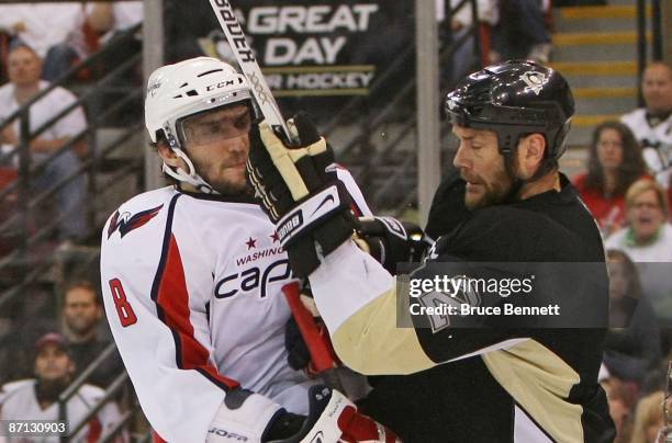 Alex Ovechkin of the Washington Capitals is hit by Hal Gill of the Pittsburgh Penguins during Game Six of the Eastern Conference Semifinal Round of...