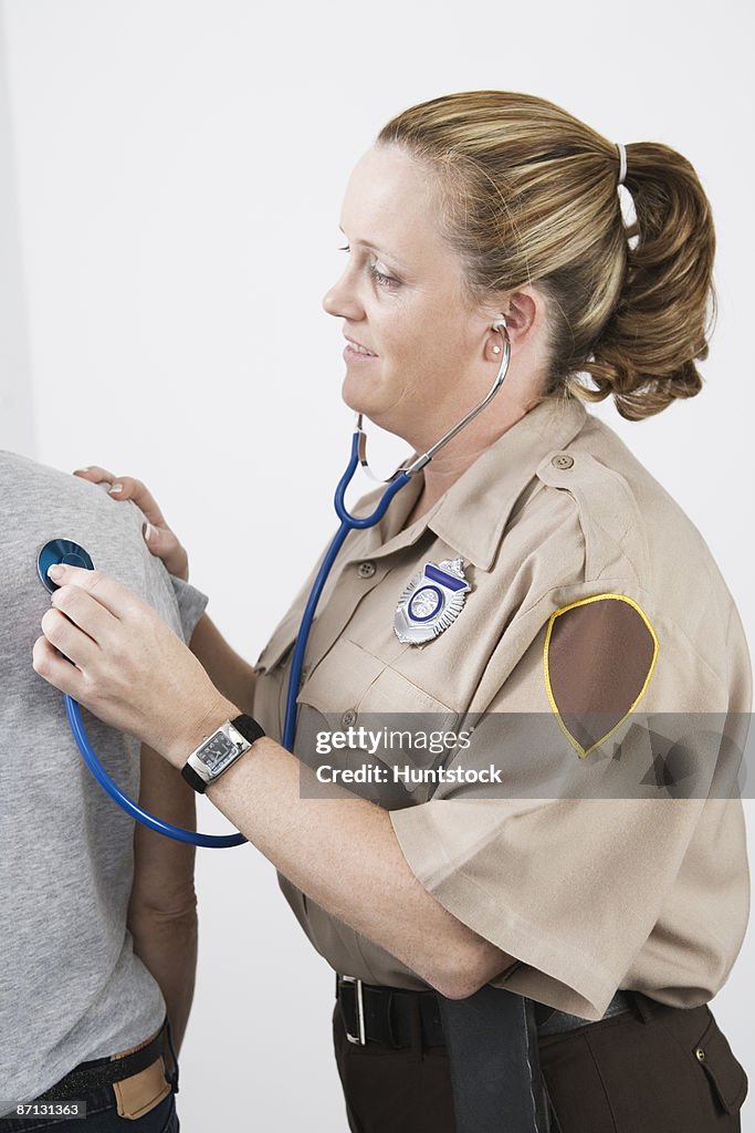 Emergency Medical Service officer checking pulse of a patient