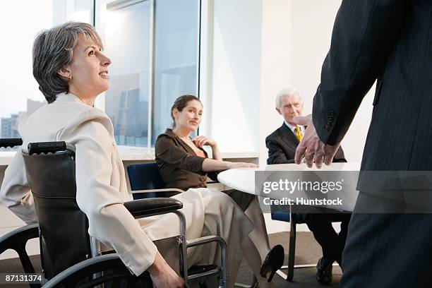 view of businesspeople sitting in an office - massachusetts conference for women stock-fotos und bilder