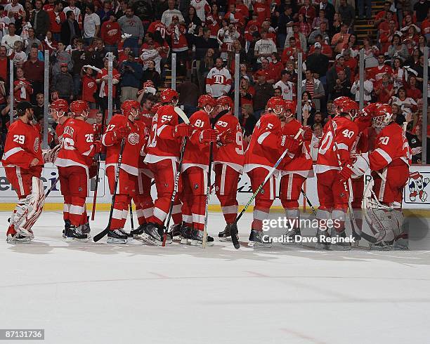 Chris Osgood of the Detroit Red Wings is congradulated by teammates on the win after Game Five of the Western Conference Semifinal Round of the 2009...