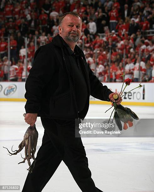 Al Sobotka, the Zamboni driver of the Detroit Red Wings, picks up an Octopus a plush duck and three red roses after Game Five of the Western...