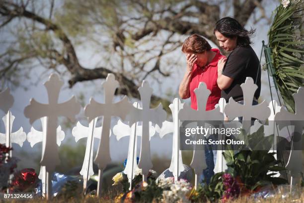 Maria Durand and her daughter Lupita Alcoces visit a memorial where 26 crosses stand in a field on the edge of town to honor the 26 victims killed at...