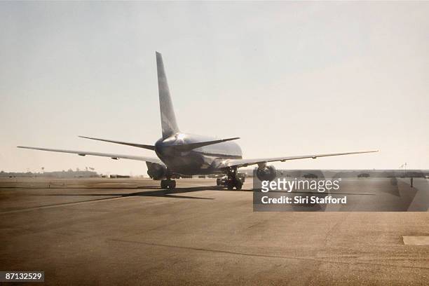 view of plane on runway before takeoff - airplane runway stockfoto's en -beelden