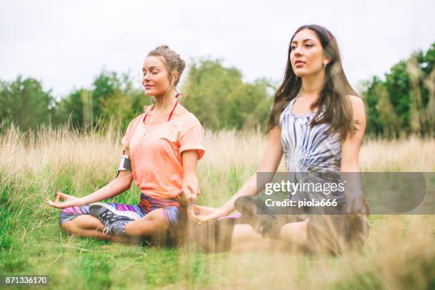 sporty women doing yoga together - running spikes stock pictures, royalty-free photos & images