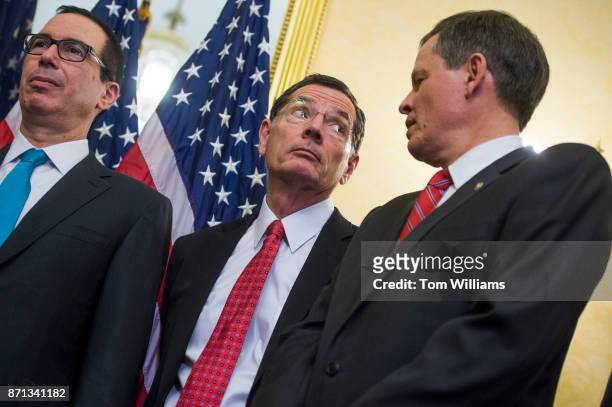 From left, Treasury Secretary Steven Mnuchin, Sens. John Barrasso, R-Wyo., and Steve Daines, R-Mont., attend a news conference in the Capitol where...