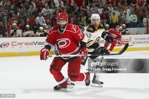 Erik Cole of the Carolina Hurricanes skates against Chuck Kobasew of the Boston Bruins during Game Four of the Eastern Conference Semifinal Round of...