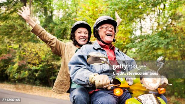 happy senior couple on scooter - motor scooter stock pictures, royalty-free photos & images