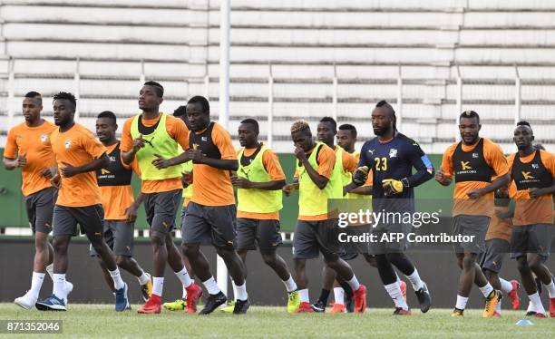 Ivory Coast's national team players run during a training session on November 7, 2017 at the Felix Houphouet-Boigny stadium in Abidjan ahead of the...