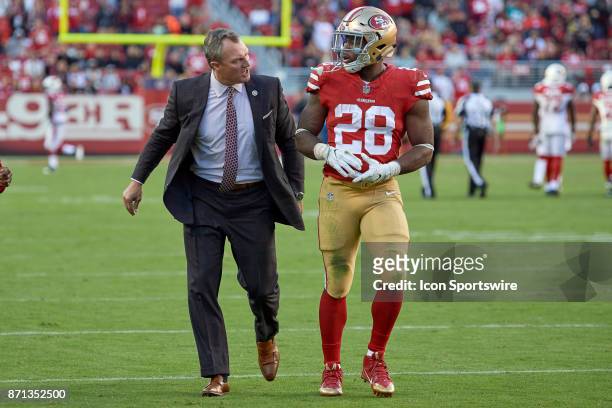 San Francisco 49ers General Manager John Lynch walks off the field as he talks with San Francisco 49ers running back Carlos Hyde who was ejected...