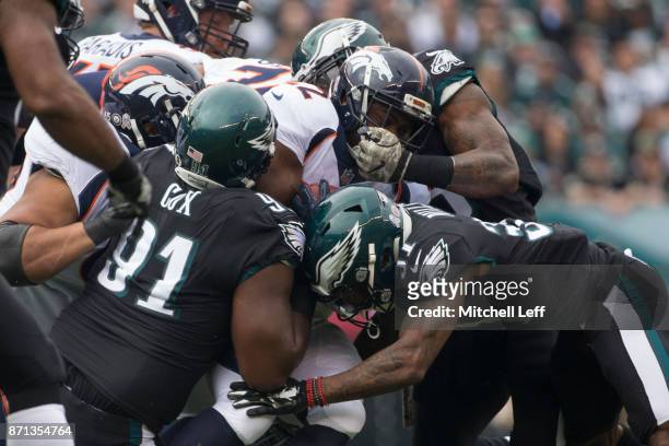 Anderson of the Denver Broncos runs the ball and is tackled by Fletcher Cox, Jalen Mills and Nigel Bradham of the Philadelphia Eagles at Lincoln...