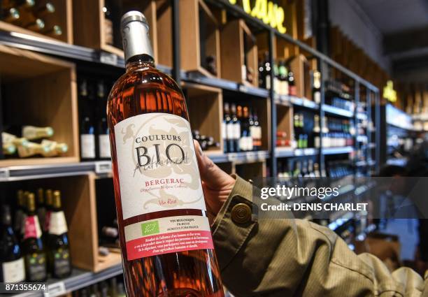 In this photograph taken on November 7 a customer looks at organic products in an Auchan 'Bio' supermarket on the outskirts of Lille in northern...