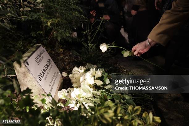 Person lays a white rose at the plaque reading "From people of Bagneux in memory of Ilan Halimi, victim of barbarity, antisemitism and racism" during...