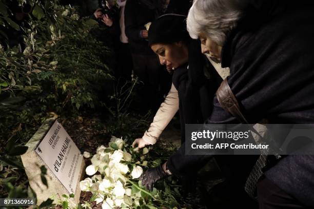 People lay a white rose at the plaque reading "From people of Bagneux in memory of Ilan Halimi, victim of barbarity, antisemitism and racism" during...