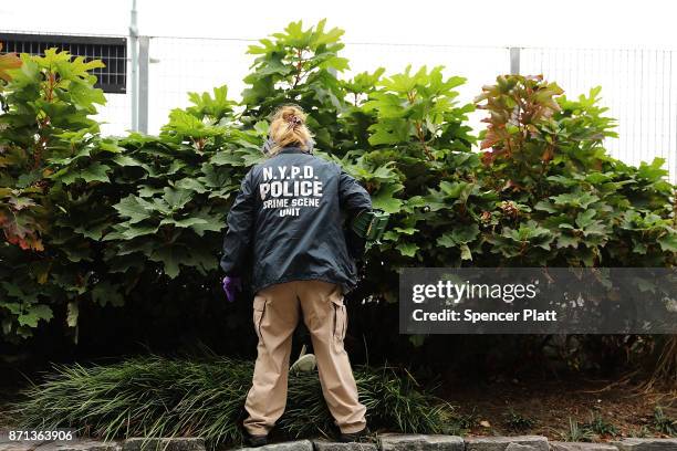 Member of the police department's crime scene unit searches the location where terrorist Sayfullo Saipov drove down a Manhattan bike path and went on...