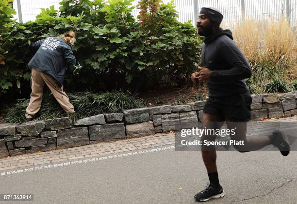 Member of the police department's crime scene unit searches the location where terrorist Sayfullo Saipov drove down a Manhattan bike path and went on...